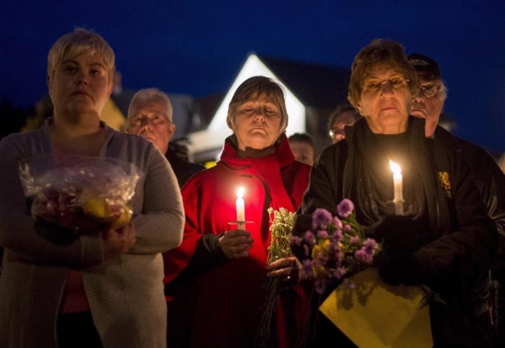 Mourners hold a candlelit vigil in remembrance of Carol Culleton, Anastasia Kuzyk and Natalie Warmerdam in Wilno, Ont. on Friday, Sept. 25, 2015.