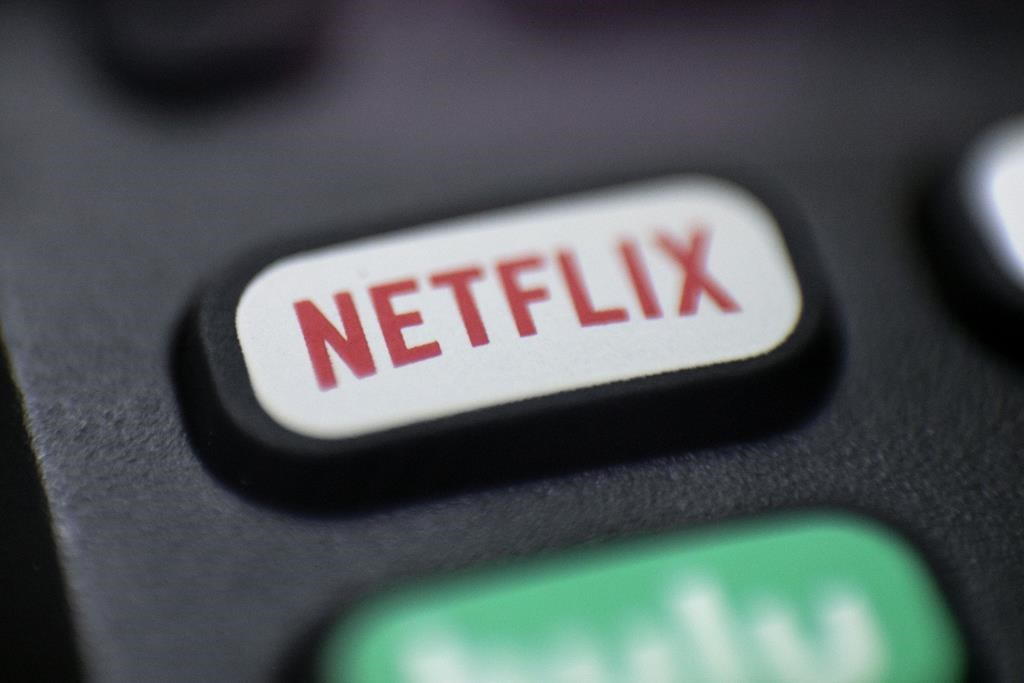 This Aug. 13, 2020, photo shows a logo for Netflix on a remote control in Portland, Ore. Netflix is launching a development program exclusively for diverse Canadian writers in film and television. (AP Photo/Jenny Kane, file).
