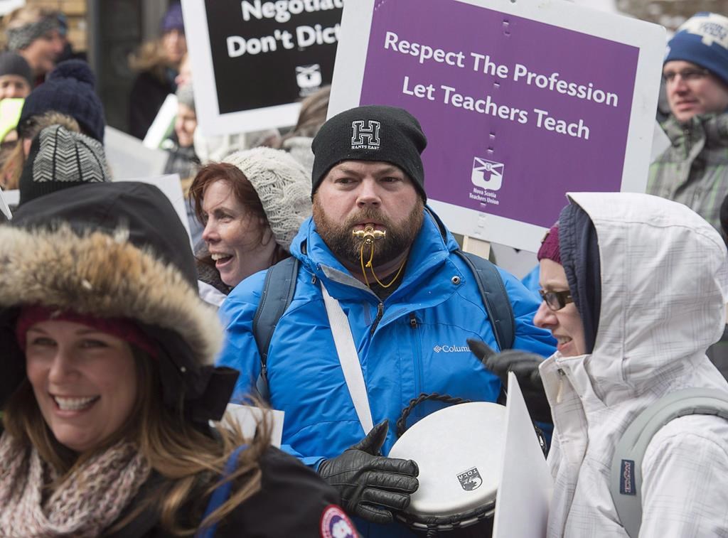 Teachers participate in a one-day, provincewide strike to protest legislation imposing a four-year contract, outside the legislature in Halifax on Friday, Feb. 17, 2017. A Nova Scotia judge has found a provincial law which imposed a labour contract on teachers to be unconstitutional, almost five years after it was passed by the former Liberal government. 