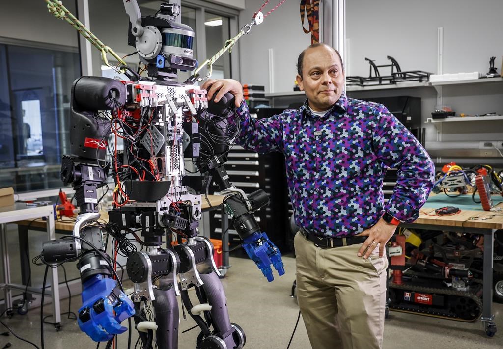 Schulich School of Engineering Prof. Alejandro Ramirez-Serrano leans on one of his robots at the University of Calgary’s unmanned vehicles robotarium lab in Calgary on Tuesday, June 14, 2022.