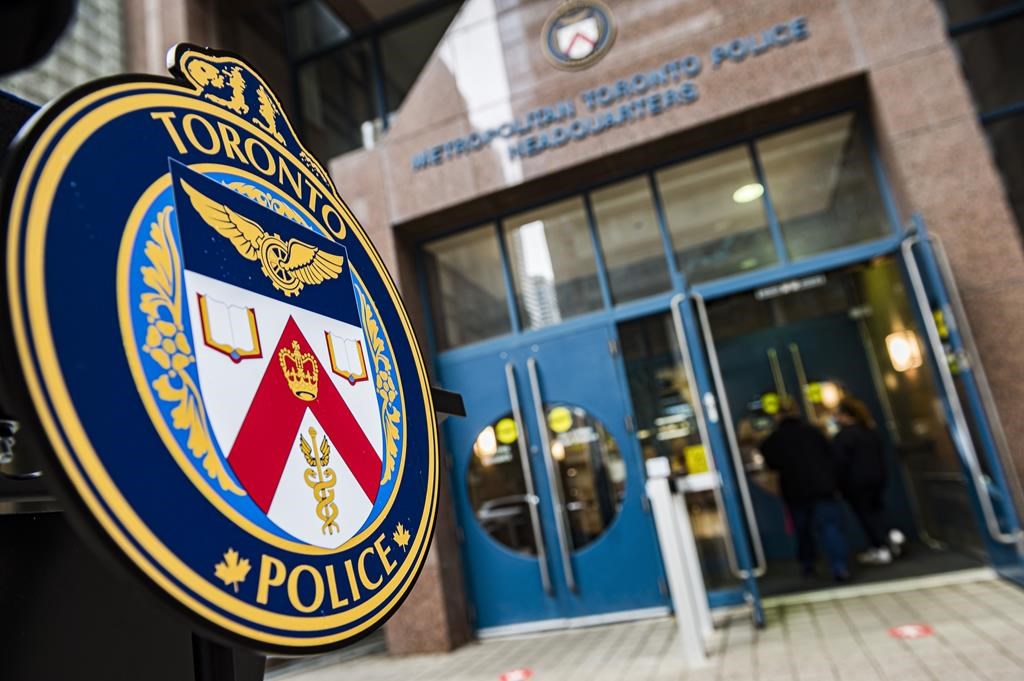 The Toronto Police Services emblem is photographed during a press conference at TPS headquarters, in Toronto on Tuesday, May 17, 2022. Toronto police say a 33-year-old man has been charged after allegedly setting a woman on fire on a city bus on Friday in what is now being investigated as a suspected hate crime. THE CANADIAN PRESS/Christopher Katsarov.
