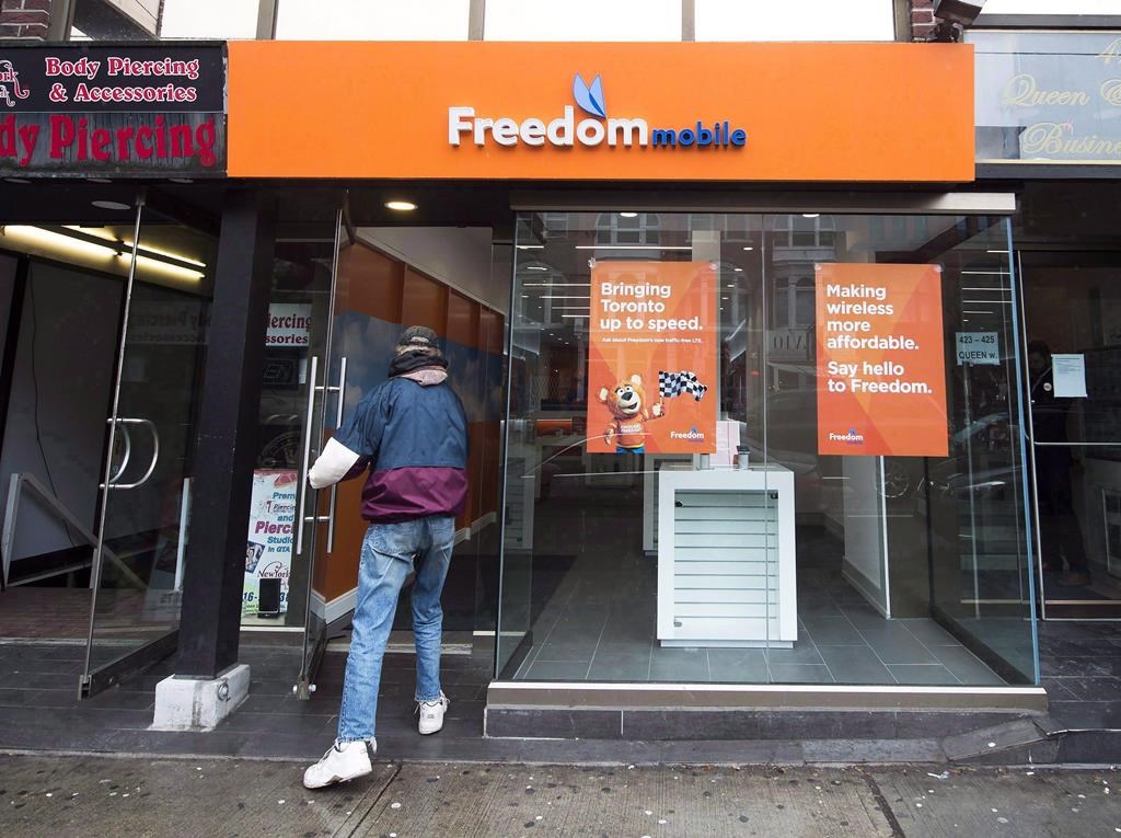 Photo of a person entering a freedom mobile store