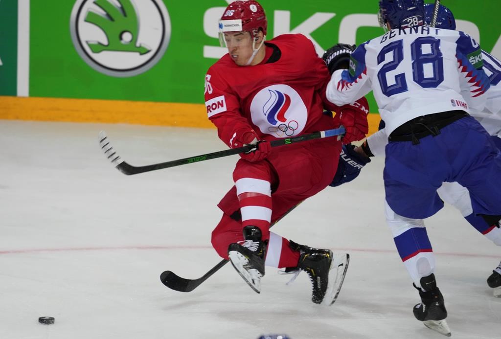 Martin Gernat of Slovakia, right, and Andrei Kuzmenko of Russia fight for a puck during the Ice Hockey World Championship group A match between the Slovakia and Russia at the Olympic Sports Center in Riga, Latvia, Monday, May 24, 2021. 