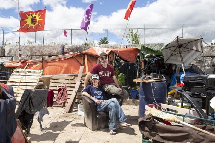 Will House and Jen Draper are photographed outside their home at a large homeless encampment, in Kitchener, Ont., on Monday June 27, 2022. 