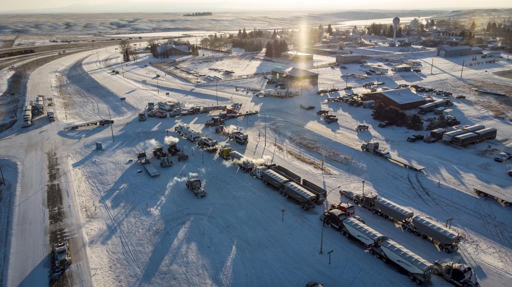 A truck convoy of anti-COVID-19 vaccine mandate demonstrators blocked the highway at the busy U.S. border crossing in Coutts, Alta., on February 2, 2022. A judge has reserved her decision on whether to grant bail for the fourth man charged with conspiracy to commit murder at a border blockade earlier this year in southern Alberta. Jerry Morin, 40, attended the two-day hearing in Lethbridge, Alta., by video. Queen's Bench Justice Johnna Kubik says she would give her ruling on July 18. THE CANADIAN PRESS/Jeff McIntosh.