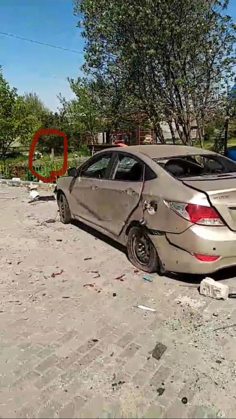 A screengrab from a video of the front yard of the Kuznetsovas’ apartment complex in Mariupol. Their daughter, Iryna, has circled her father’s grave in red.