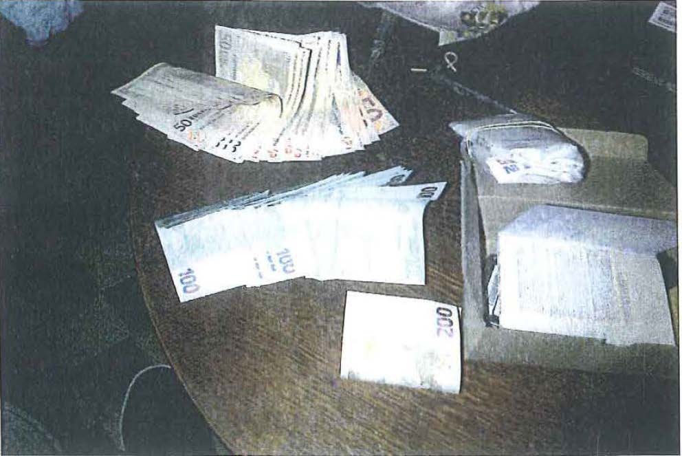 A passport, hard drive and cash found hidden in a carboard box inside a stereo system in the cabin where Coban was arrested.