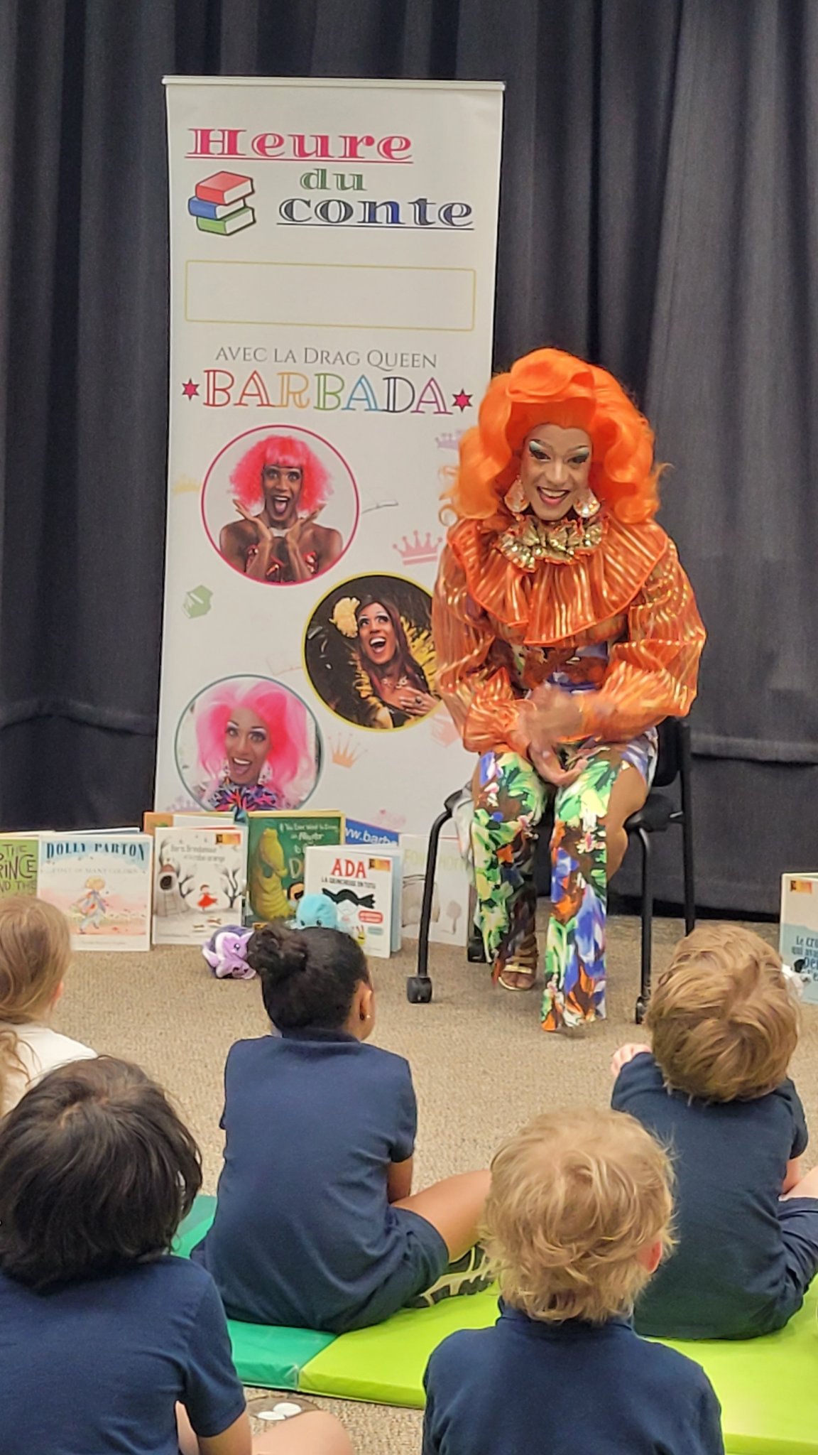Drag queen Barbada reading in front of Kindergarten children at the Dorval Library.