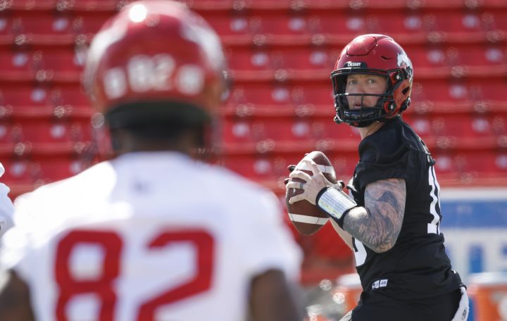 Calgary Stampeders quarterback Bo Levi Mitchell, right, looks to Malik Henry during opening day of the CFL team's training camp in Calgary, Sunday, May 15, 2022.