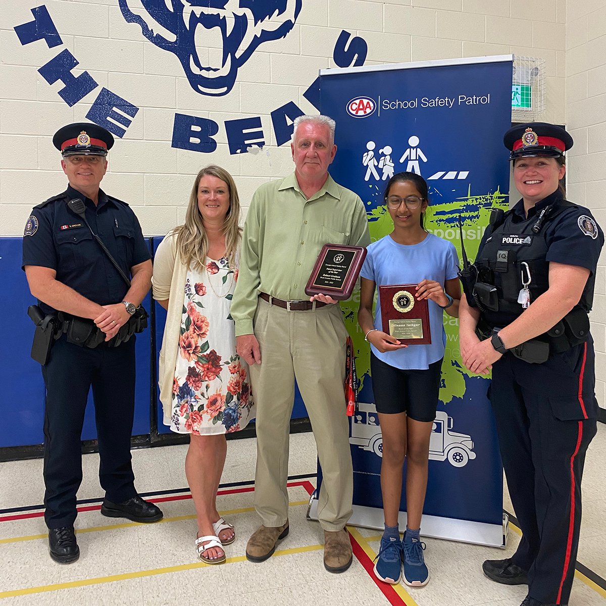 Brant Avenue Public School teacher Robb Graham and student Dilnaaz Tathgar receive honours for their work on the school's safety patrol.