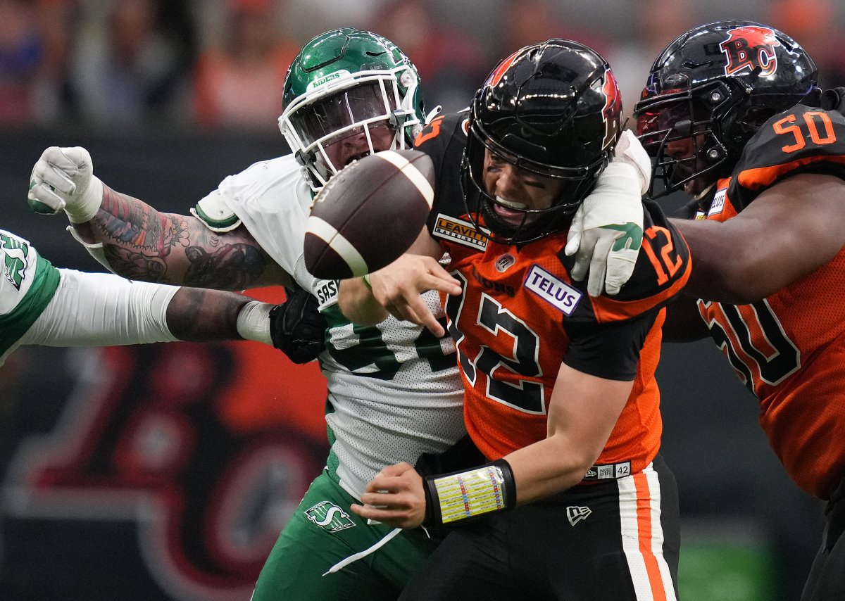 B.C. Lions quarterback Nathan Rourke is sacked by Garrett Marino of the Saskatchewan Roughriders during first-half CFL pre-season action in Vancouver, B.C., on Friday, June 3, 2022.