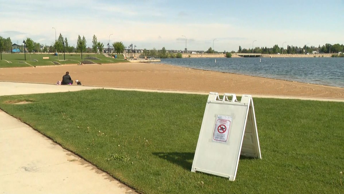 A picture warning of the closure of Chestermere Lake, Alta., due to excess fecal matter is pictured on June 17, 2022.