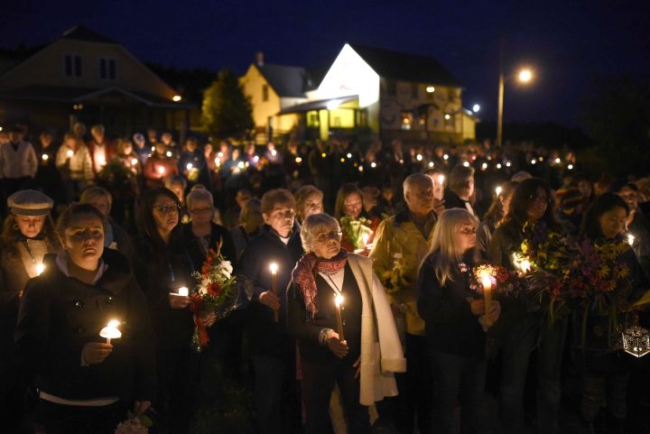Mourners hold a candlelit vigil in remembrance of Carol Culleton, Anastasia Kuzyk and Natalie Warmardam in Wilno, Ont. on Friday, Sept. 25, 2015. 