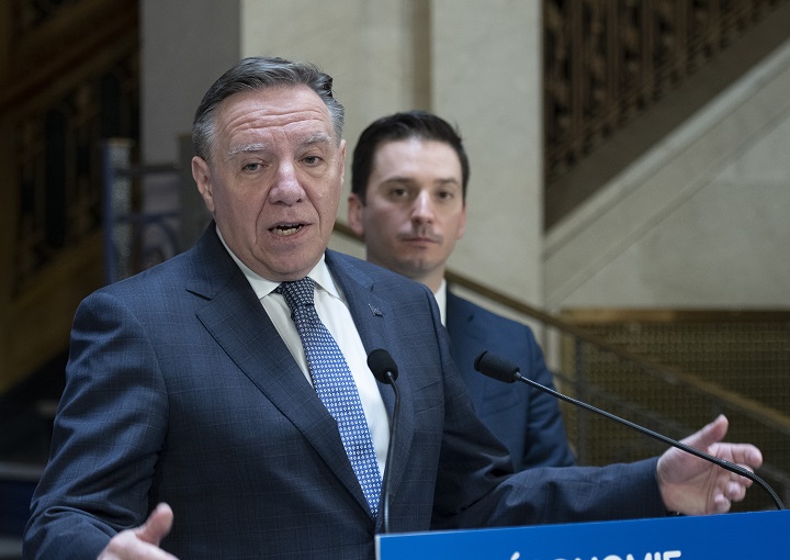 Quebec Premier François Legault appraises the ending session at a news conference, Friday, June 10, 2022 at the legislature in Quebec City. Quebec Justice Minister Simon Jolin-Barrette, right, looks on. Quebecers will go to the polls for a general election on Oct. 3 of this year.  