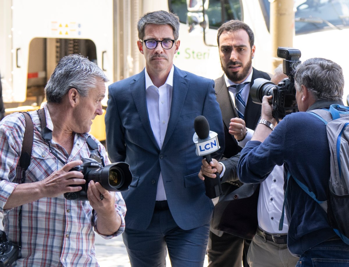 Former Parti Québécois leader André Boisclair makes his way through the media as he arrives for his court appearance on sexual assault charges, Monday, June 20, 2022, in Montreal.