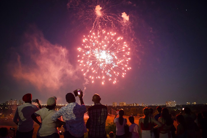 People watch a fireworks show in Toronto as part of Canada Day celebrations, in Toronto on Sunday, July 1, 2018.