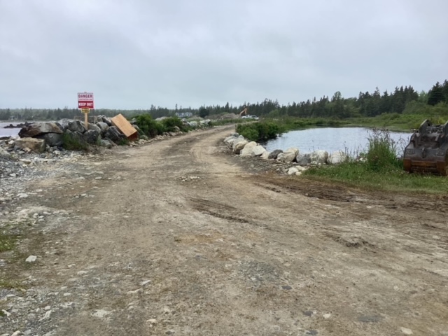 Kelly and an excavation company have been fined for partially infilling a pond to construct a road.