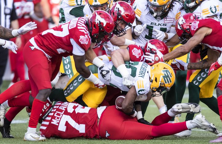 Calgary Stampeders tackle Edmonton Elks Christian Saulsberry (20) during first half CFL pre season action in Edmonton, Friday, June 3, 2022. 