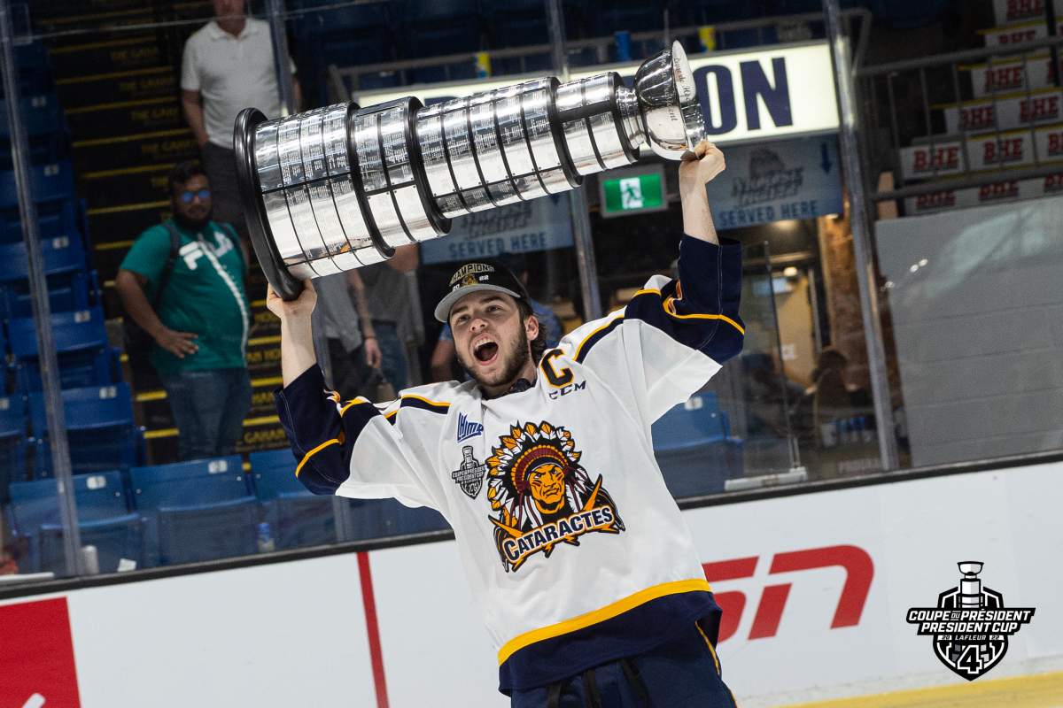 Shawinigan Cataractes captain Mavrik Bourque holds up the President’s trophy.