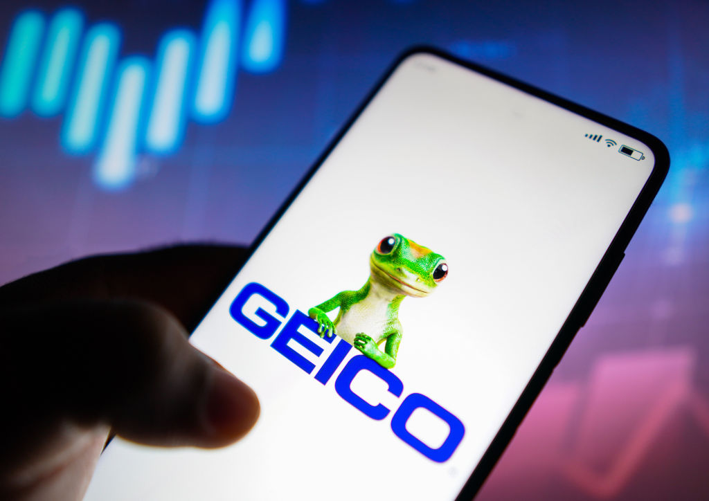 In this photo illustration, the Geico logo (which stands for Government Employees Insurance Company) is seen displayed on a smartphone.