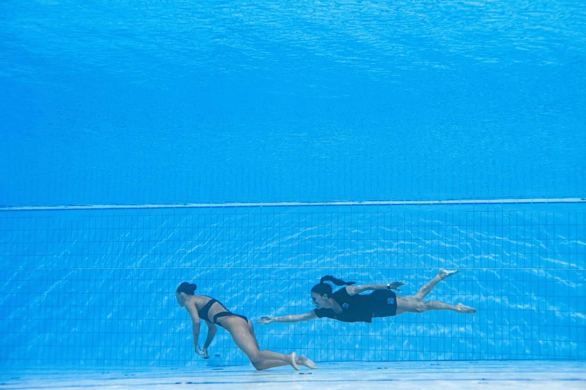A member of Team USA (R) recovers USA's Anita Alvarez (L), from the bottom of the pool during an incident in the women's solo free artistic swimming finals, during the Budapest 2022 World Aquatics Championships at the Alfred Hajos Swimming Complex in Budapest on June 22, 2022.