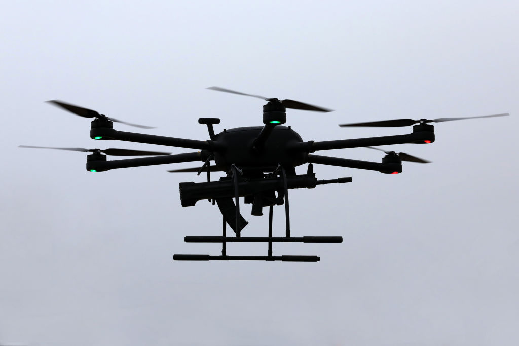 A police drone carries 95-1 assault rifle in a drill on January 9, 2022 in Zhoushan, Zhejiang Province of China.