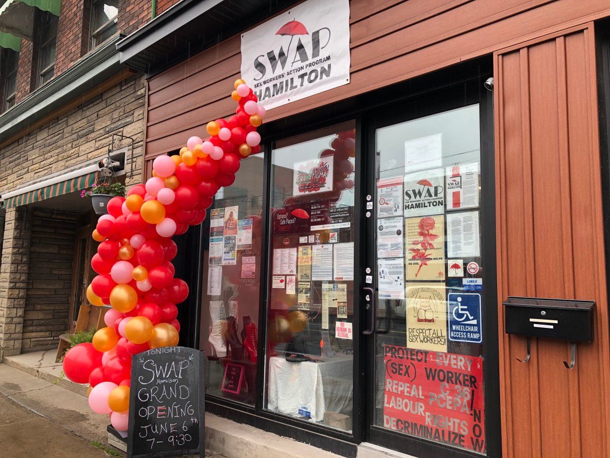 The exterior of SWAP Hamilton's location on Barton Street East, with the windows full of posters and a balloon display in front of the windows.