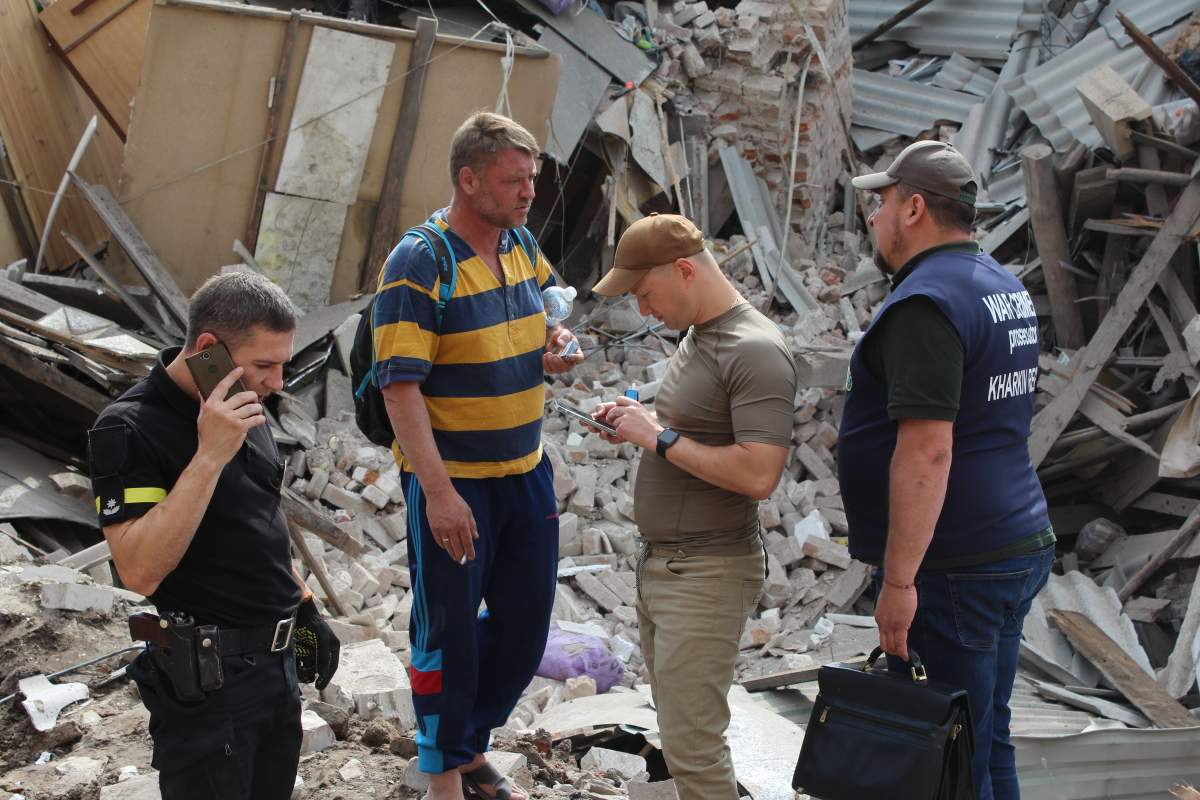 Investigators at scene of Russian missile attack on apartment building in Kharkiv, June 25, 2022.