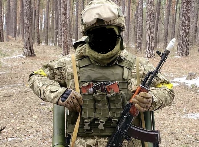 A Ukrainian soldier who became a Russian prisoner of war. His face is concealed to protect his identity.