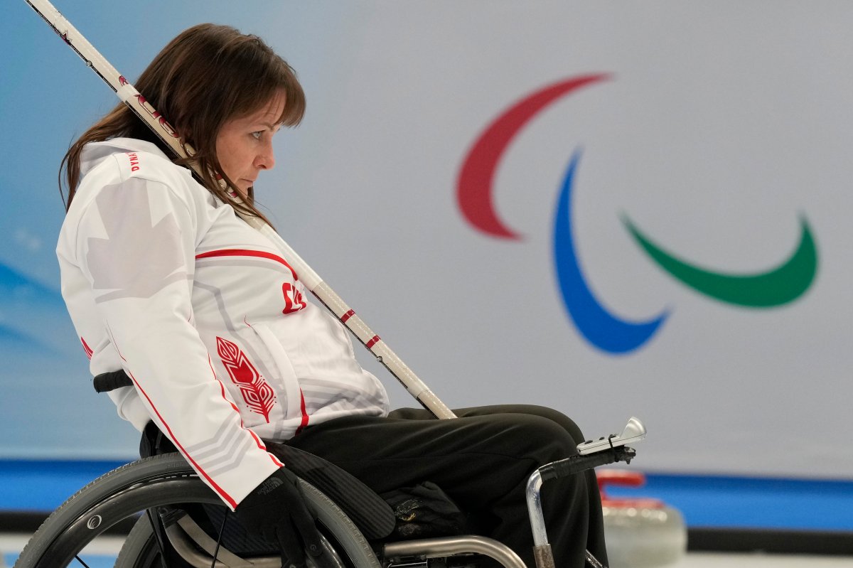 Canada’s Ina Forrest lines up her push as she and her teammates compete against Sweden during the wheelchair curling competition at the 2022 Winter Paralympics in Beijing on Monday, March 7, 2022.
