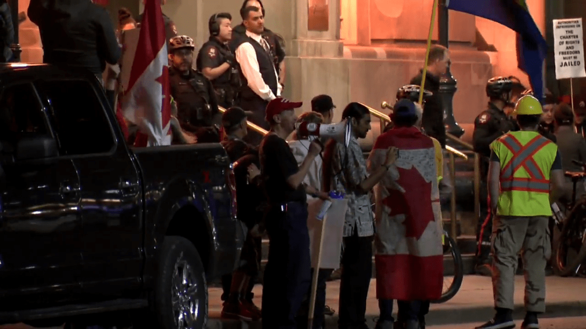 Protesters gather outside the Fairmont Palliser hotel in Calgary Wednesday, June 1, 2022.