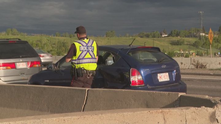 Police investigate a two-vehicle collision at Memorial Drive and Deerfoot Trail in Calgary on June 11, 2022.