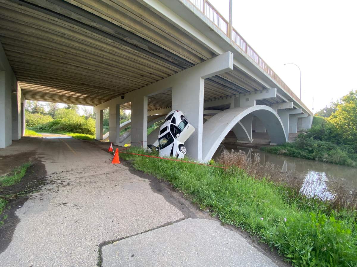 Edmonton police say no one was present when they arrived to an upside down car under the Campbell Bridge on June 16, 2022.