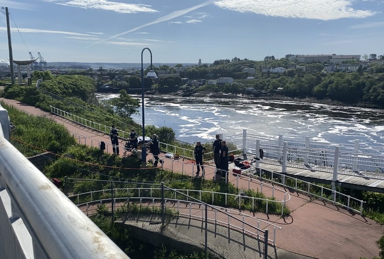 Saint John Police and emergency responders are seen at Reversing Falls Bridge after a man fell over.