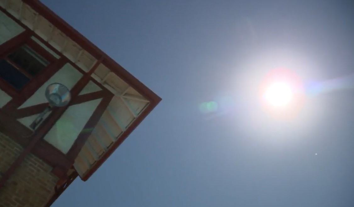 A picture of the sky showing a hazy sun.