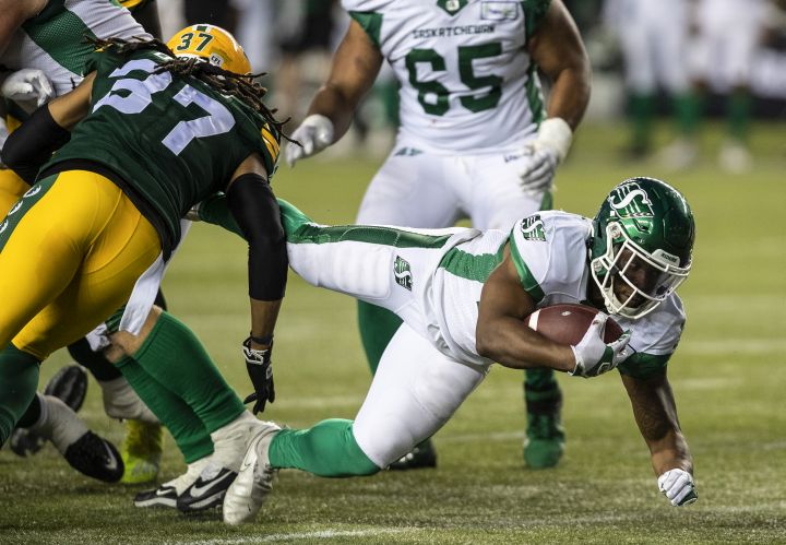 Saskatchewan Roughriders’ Jamal Morrow (25) is tackled by Edmonton Elks’ Treston Decoud (37) during second half CFL action in Edmonton, Alta., on Saturday June 18, 2022.