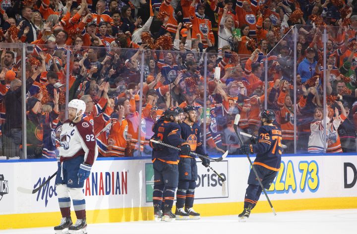 Colorado Avalanche’s Gabriel Landeskog (92) skates past as the Edmonton Oilers celebrate a goal during third period NHL conference finals action in Edmonton on Monday, June 6, 2022.
