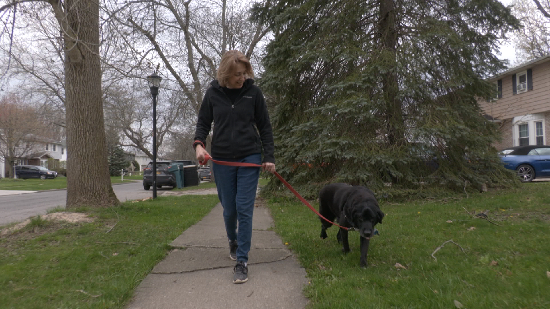 Kris Depowski walks her dog Murphy.