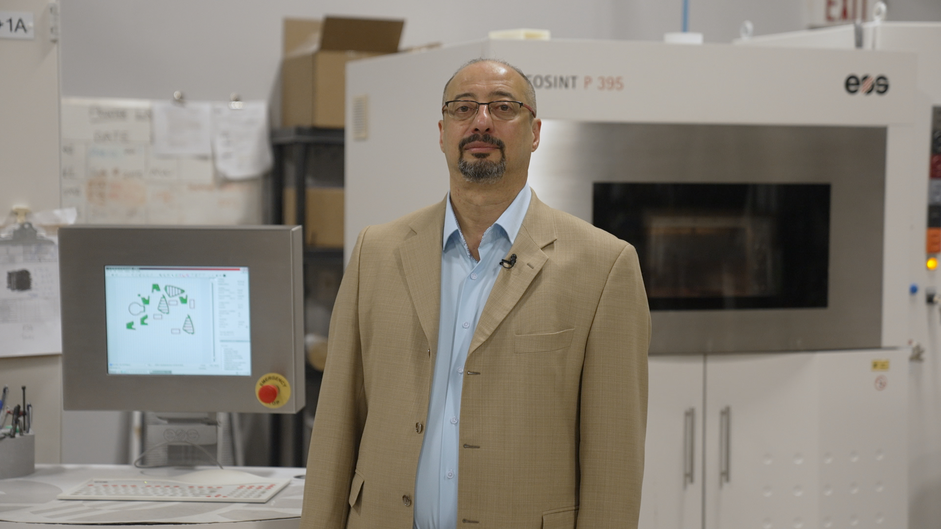 A man stands inside a 3D printing factor