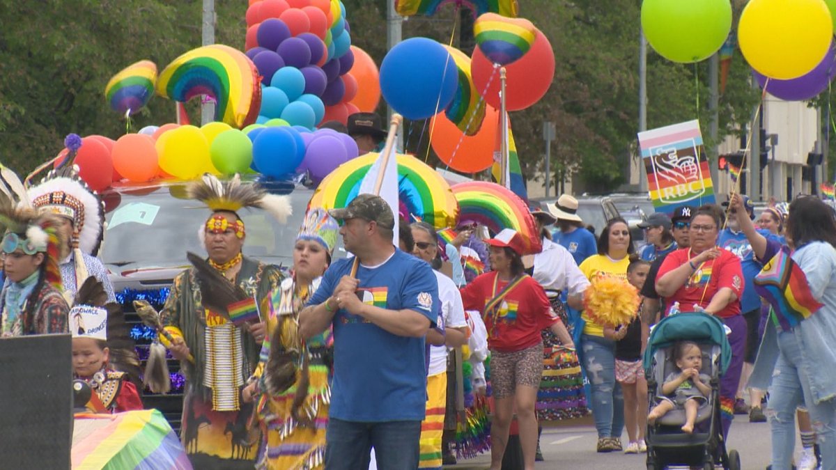 The 2022 Regina Pride parade marching on the city streets to the Saskatchewan Legislature Building.