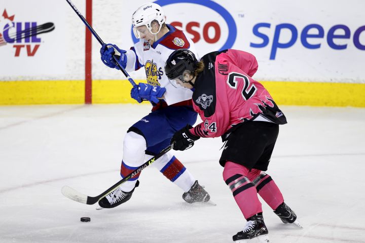 Edmonton Oil Kings player Luke Prokop, lt, battles for the puck with Calgary Hitmen player Zac Funk during WHL (Western Hockey League) hockey action in Calgary, Alta., on Saturday, March 5, 2022.  