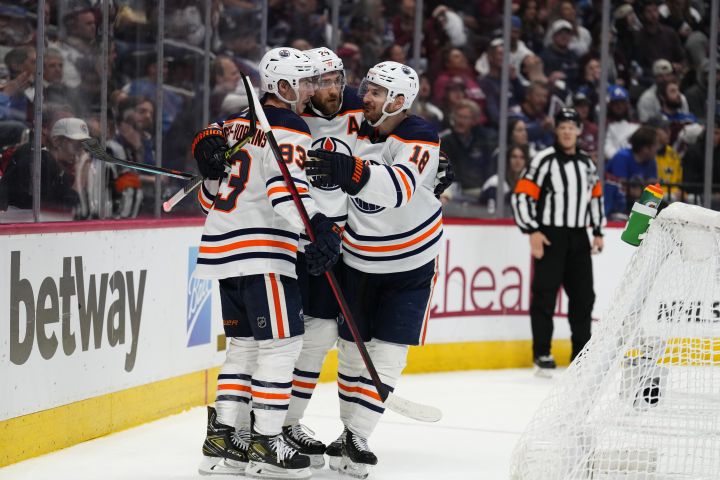 Edmonton Oilers centre Ryan Nugent-Hopkins (93) celebrates a goal against the Colorado Avalanche with Leon Draisaitl (29) and left wing Zach Hyman (18) during the third period in Game 1 of the NHL hockey Stanley Cup playoffs Western Conference finals Tuesday, May 31, 2022, in Denver.