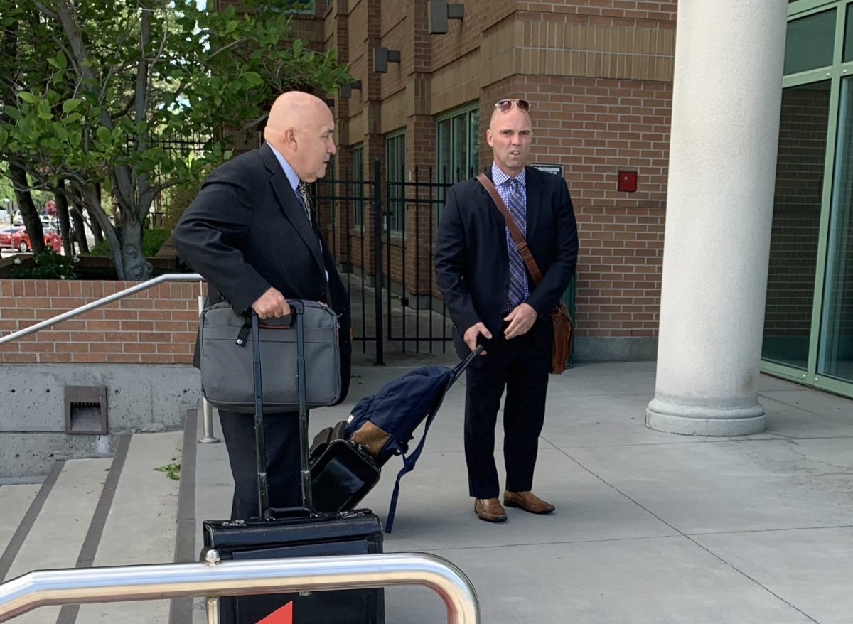 FILE Const. Siggy Pietrzak (right) and his lawyer outside the Kelowna Courthouse on June 23, 2022. T .