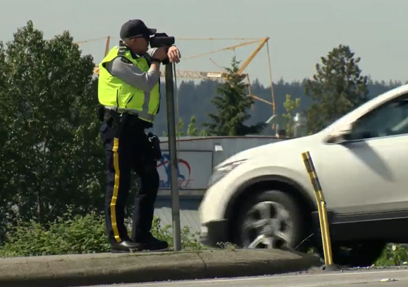 A member of the Surrey RCMP searchers for speeders at Highway 10 and Panorama Drive in Surrey, B.C. on Thurs. June 2, 2022.