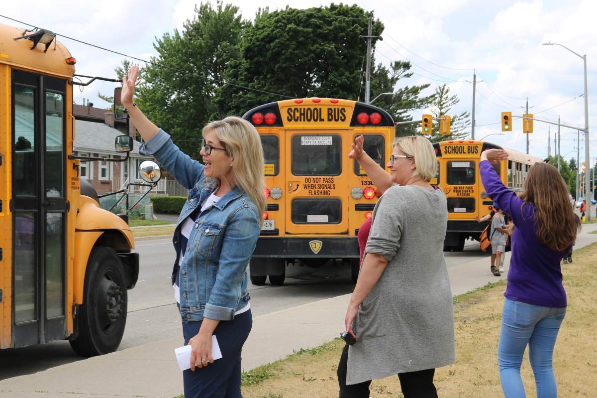 Teachers at F.D. Roosevelt Public School waving goodby to students on the last day of school in London Ontario June 29, 2022.