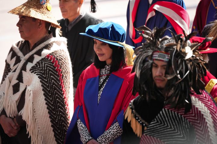 Singer and songwriter Beth Torbert, centre, known by her stage name Bif Naked, stands during a ceremony where she was conferred an honorary degree by Simon Fraser University during convocation, in Burnaby, B.C., on Friday, May 6, 2022. Torbert was named as one of the honorary recipients for 2020 however the in-person convocation ceremony that Spring was cancelled due to COVID-19. Ceremonies were held this week for spring 2020 graduates who at the time were only able to participate virtually.