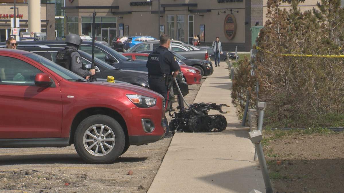 An LPS officer maneuvers a robot into a west Lethbridge apartment on June 2, 2022.