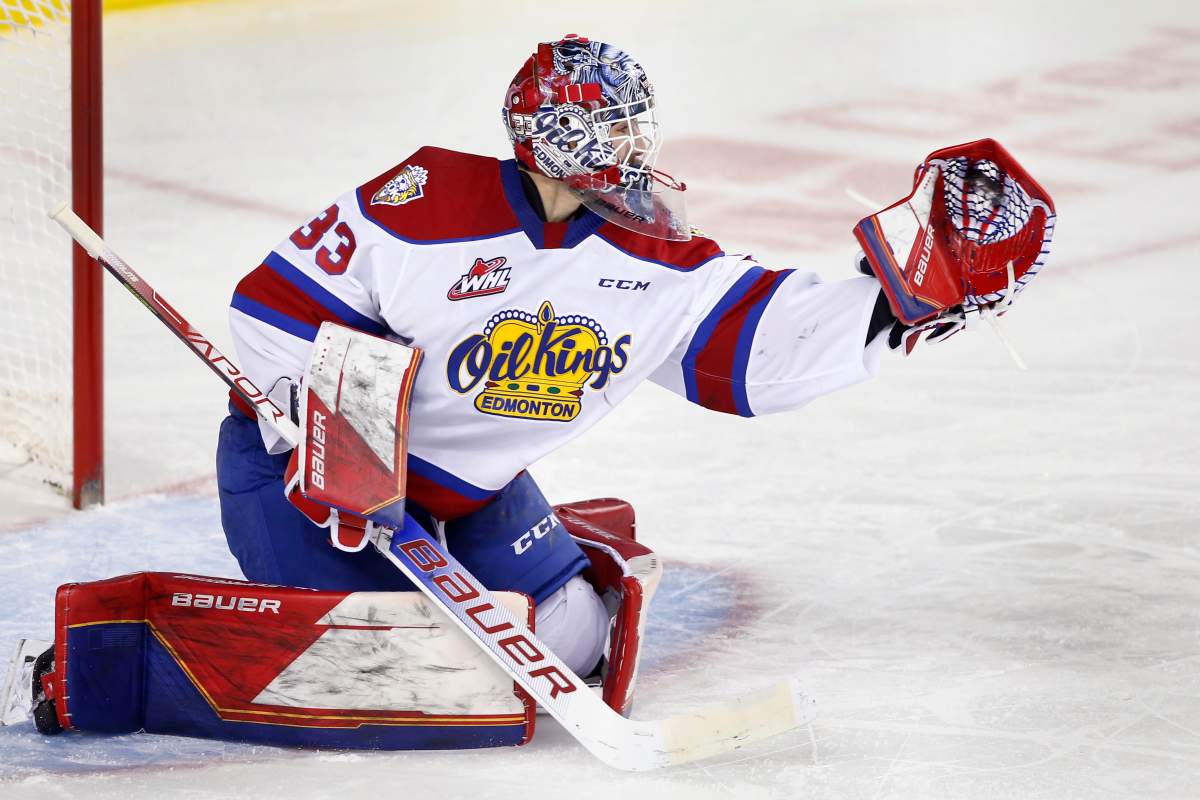 Edmonton Oil Kings goalie Sebastian Cossa makes a glove save during WHL action against the Calgary Hitmen on March 5, 2022. On Thursday, the WHL announced that the 2022-23 season will begin on Friday, Sept. 23.