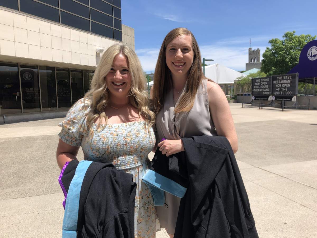 Western University faculty of education graduates Madison Vergeer and Sarah Welch picking up their gowns for convocation. June 13, 2022.