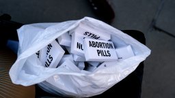 Abortion pills are passed out at a protest opposing the U.S. Supreme Court overturning of Roe v. Wade.